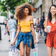 Two girls with shopping bags on a city street